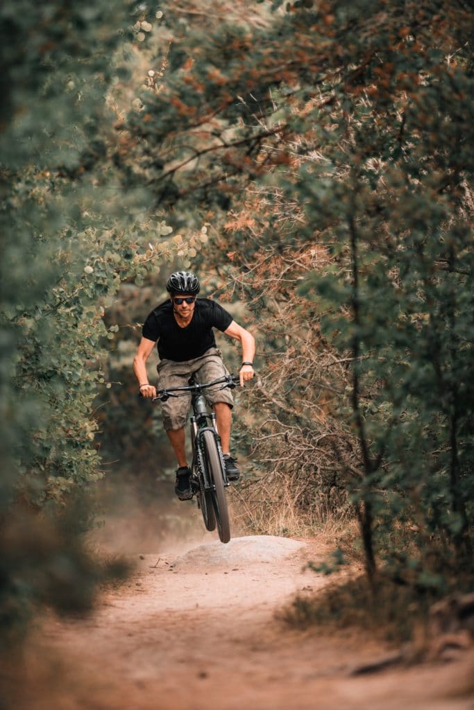 Mountain Biker Confidently Jumping