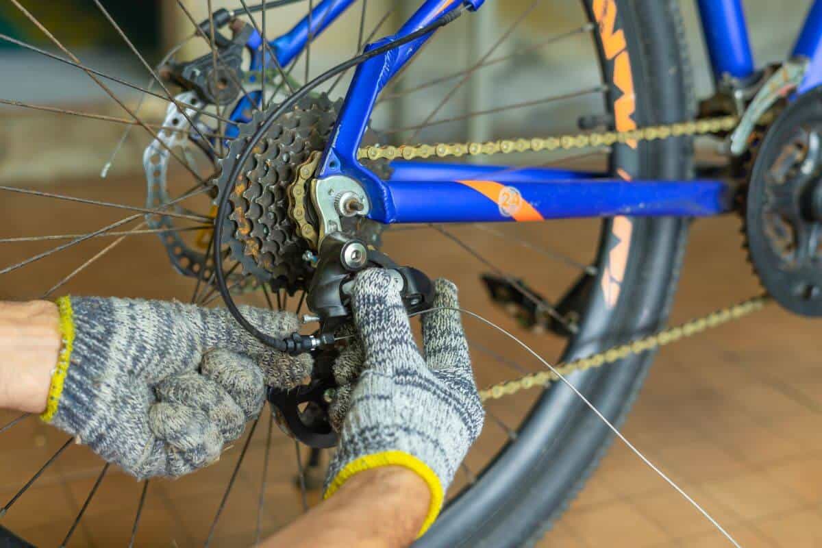 person working on mountain bike