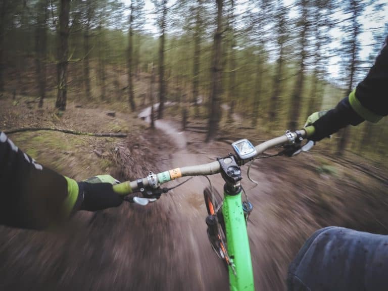 Mountain biker speeding on muddy trails