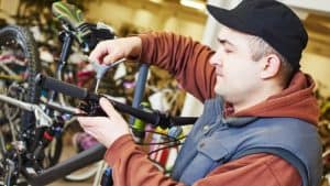 man adjusting brake lever position