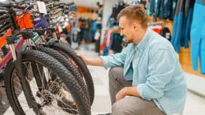 man looking at cheap bikes at store
