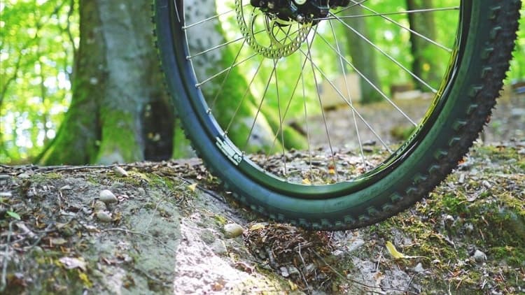 mountain bike rolling over obstacle