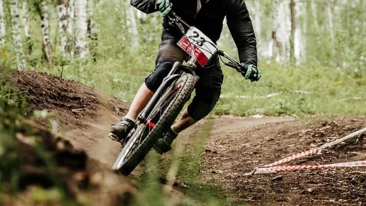 mountain biker cornering hard on mountain bike