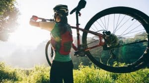 rider carrying mountain bike