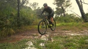 mountain biker riding in mud and water