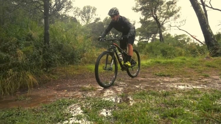 mountain biker riding in mud and water