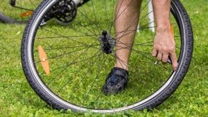 person changing bike tire innertube