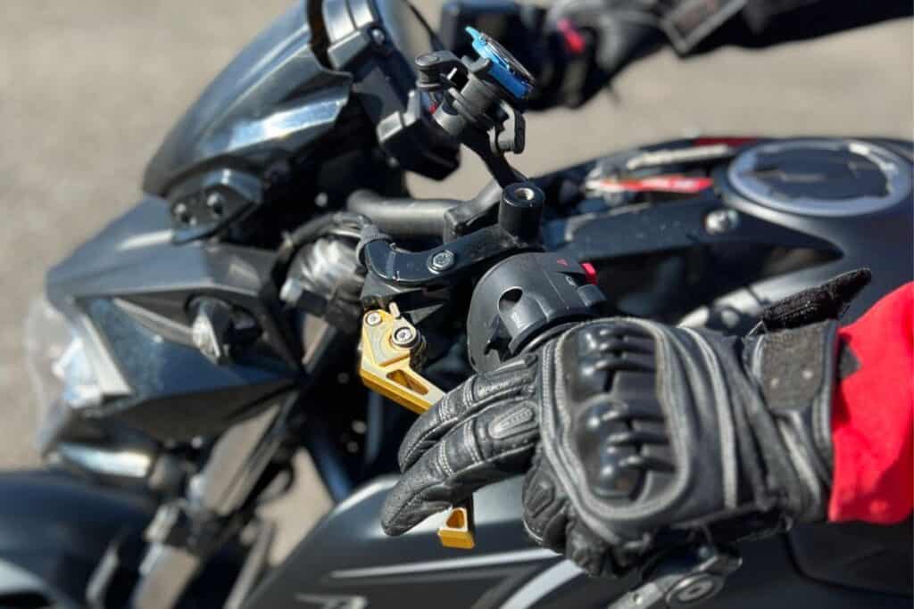 close up of rider with finger over the clutch lever