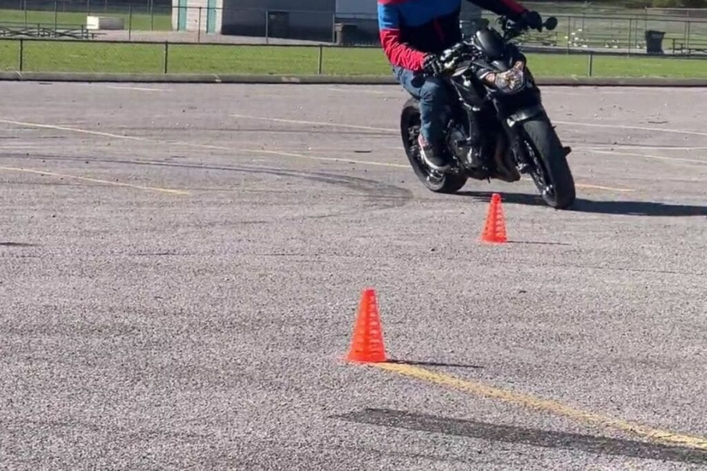 rider turning right around cones on motorcycle course