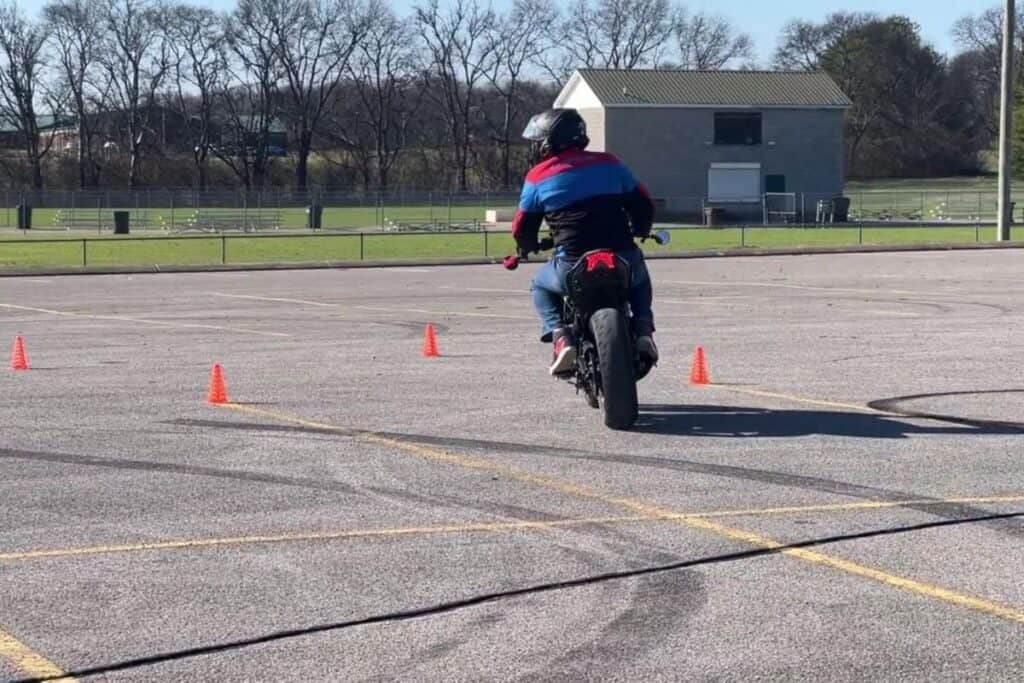 motorcycle rider looking left through turn on motorcycle course.