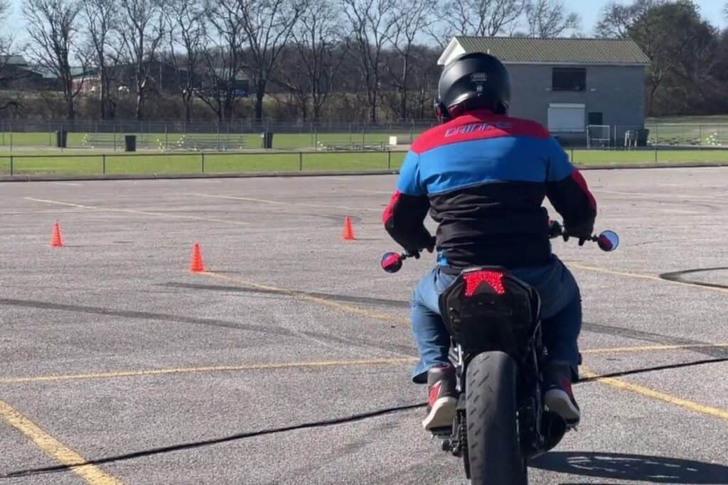 rider on motorcycle course with good view of motorcycle jacket and helmet