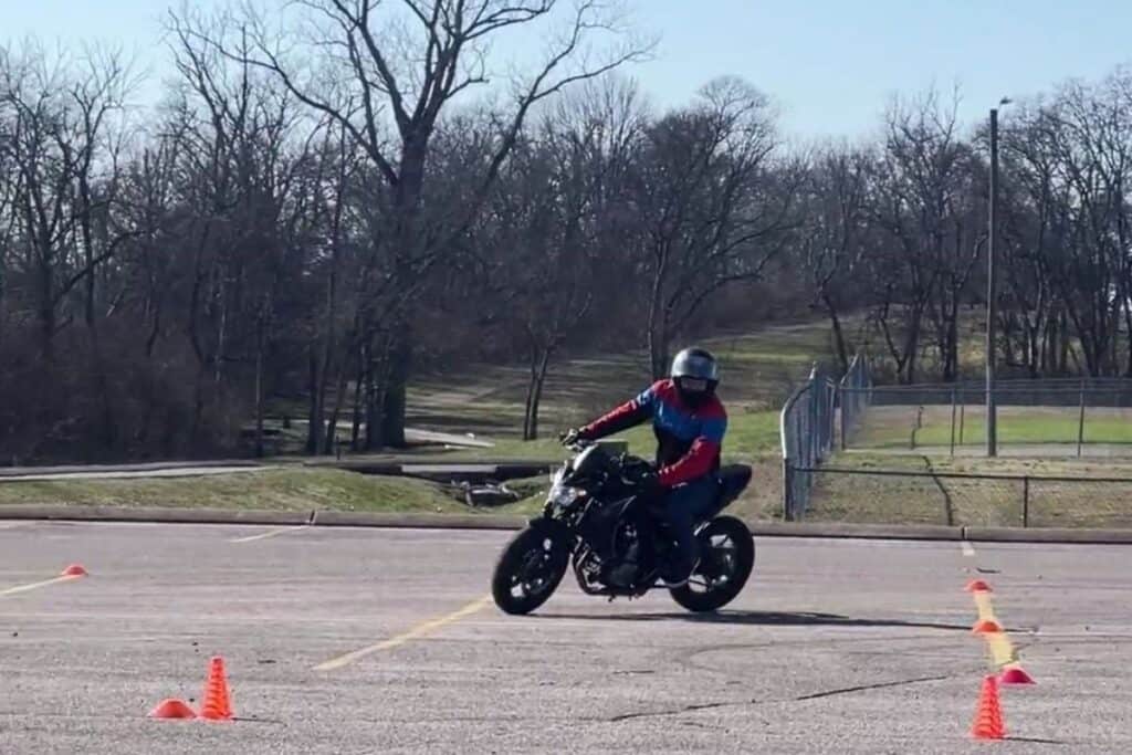 rider taking wide left turn on motorcycle course