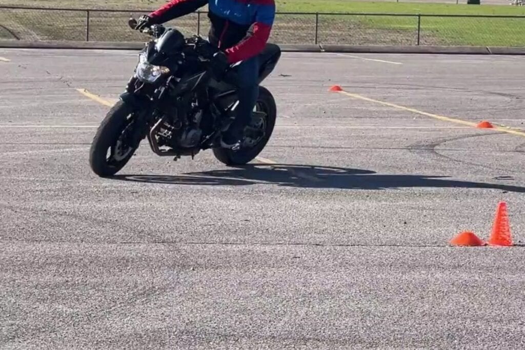 rider turning left and leaning on motorcycle course